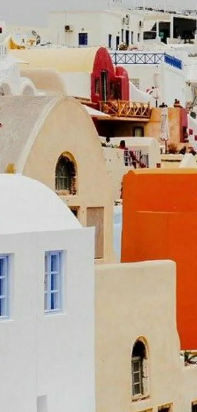 Santorini's iconic white and colorful buildings under a clear sky.