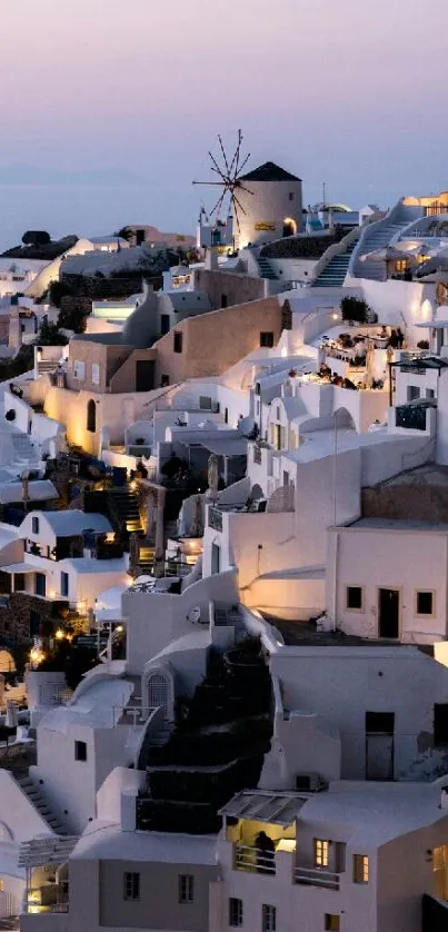 Evening view of Santorini's white buildings under a pastel sky.