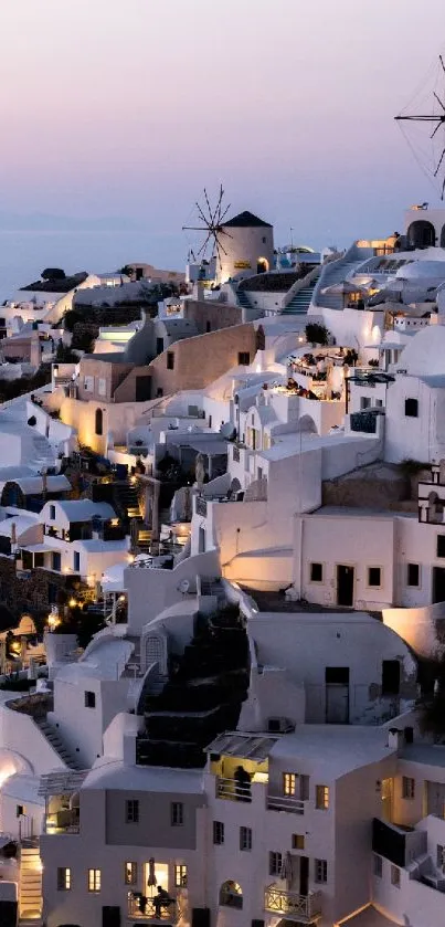 Santorini's white buildings at twilight, glowing under a calming sky.