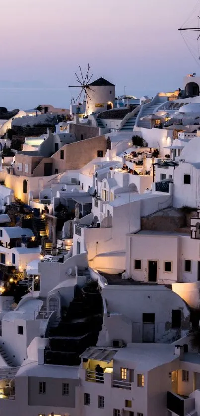 Santorini at night with illuminated buildings and classic architecture.