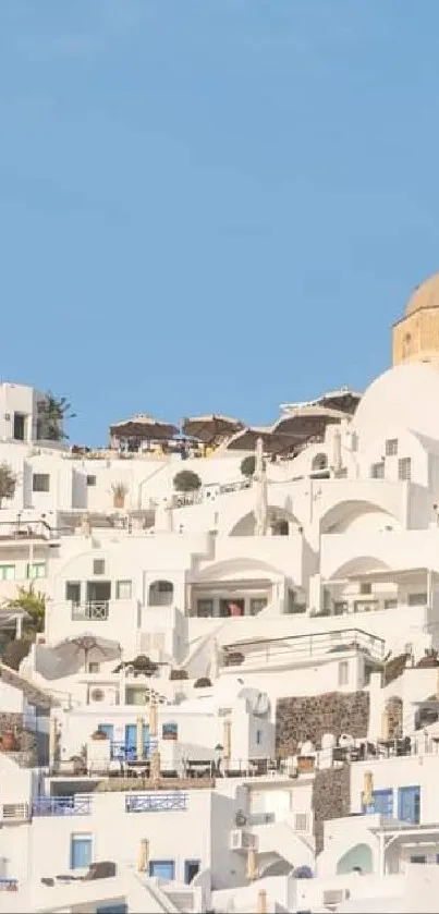 Scenic Santorini view with white buildings and blue sky.