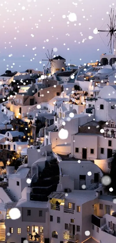 Santorini sunset with white windmills and architecture illuminated.