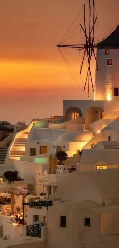 Santorini buildings and windmill at sunset.