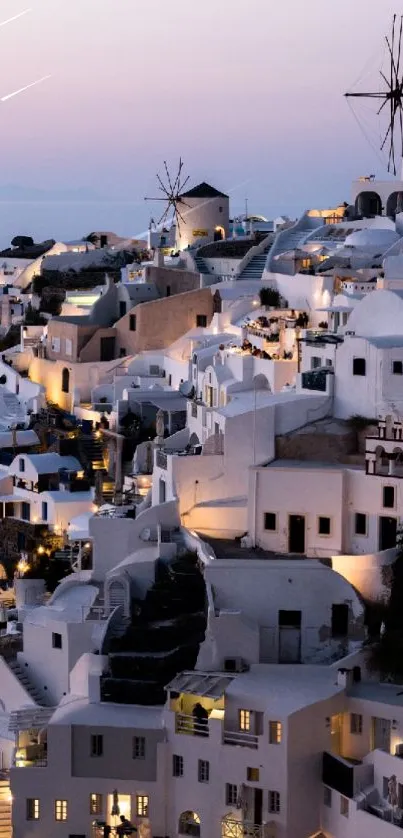 Santorini's white buildings at twilight with windmills.