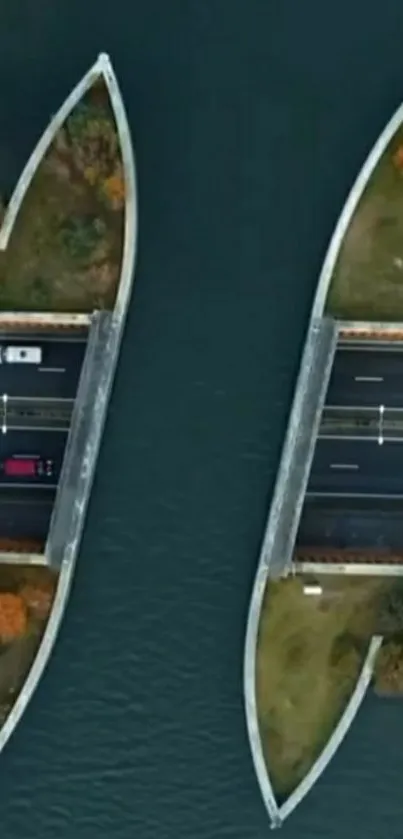 Aerial view of a scenic bridge over water, with vibrant trees.