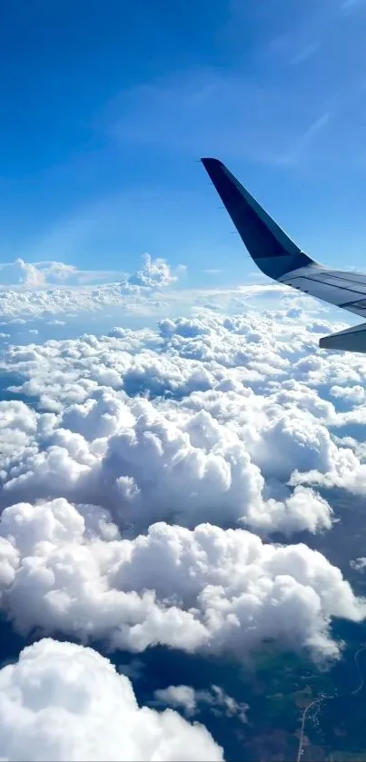 Airplane wing soaring above white clouds against a bright blue sky.