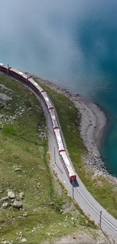 Aerial view of train by a turquoise lake in the Alps