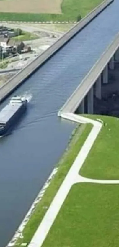 Aerial view of a canal bridge surrounded by lush green fields.