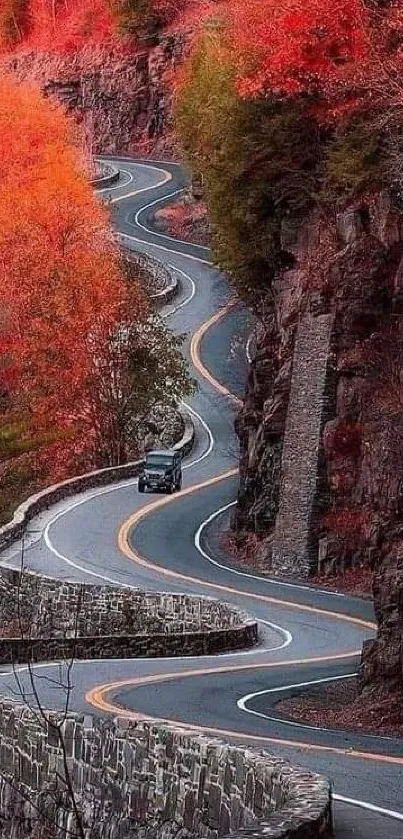 Winding road through vibrant red autumn foliage.