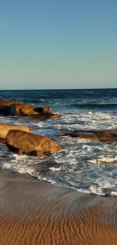 A scenic beach sunset with waves and golden sand.