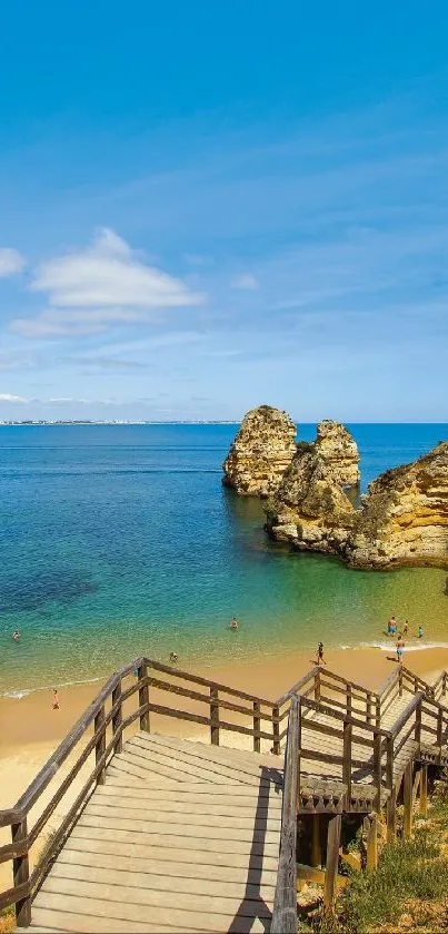 Scenic view of beach with wooden stairs and blue sky.