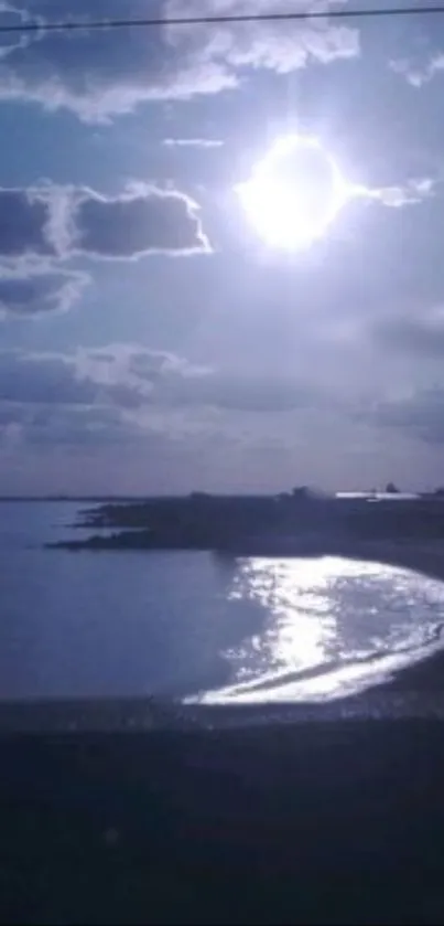 Serene sunset over a tranquil beach with clouds.