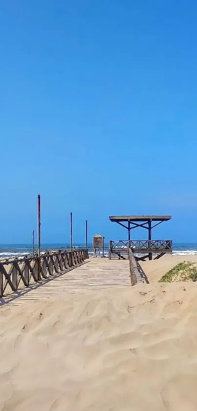 Beach walkway under a clear blue sky with sandy shores.