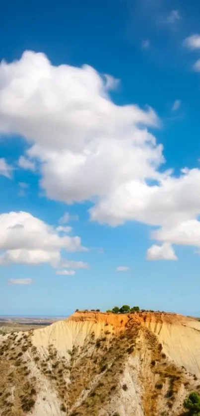 Wallpaper of blue sky with clouds over desert hills.