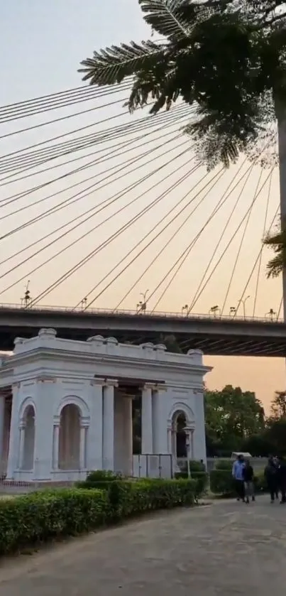 Elegant view of bridge spanning over historic monument at sunset.