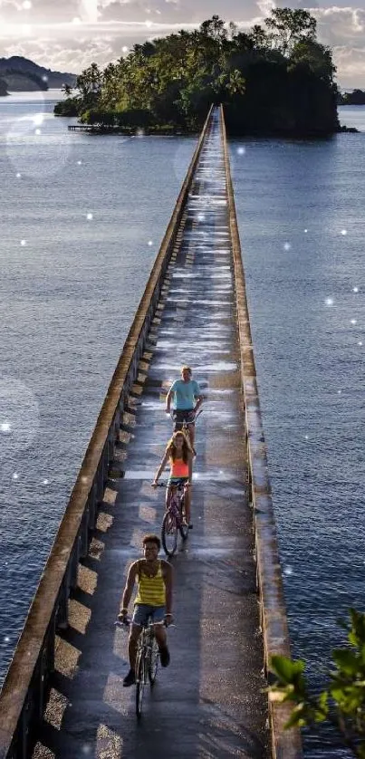 Cyclists riding over a scenic bridge surrounded by ocean and trees.