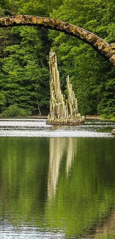 Stone bridge over reflective water in lush green forest.