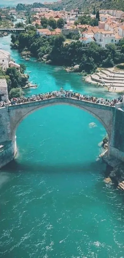 Scenic view of a turquoise river and historic bridge on mobile wallpaper.