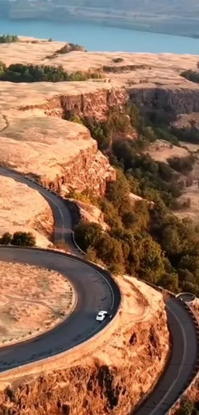 Aerial view of a winding canyon road with stunning landscapes.