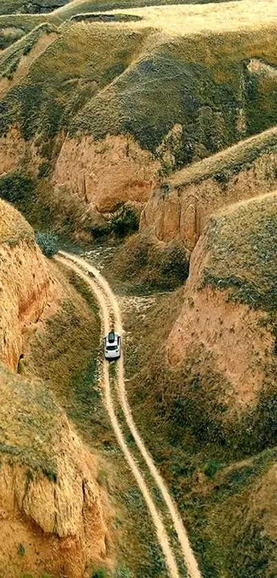 SUV on a winding road through scenic canyon landscape.