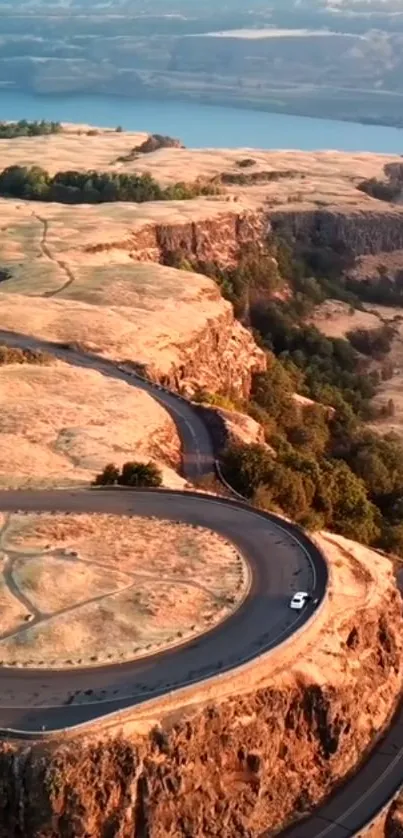 Aerial view of a winding road in a scenic canyon landscape.