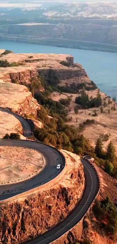 Winding road through a scenic canyon landscape with river view.