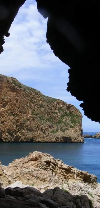 Scenic cave view overlooking coastal cliffs and ocean.