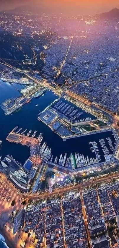 Aerial view of city harbor at sunset with vibrant lights.