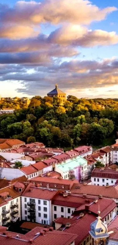 Cityscape with vibrant rooftops and scenic hills at sunset.