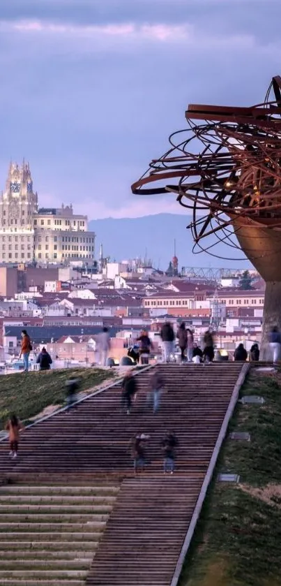 Cityscape evening view with unique sculpture in foreground.