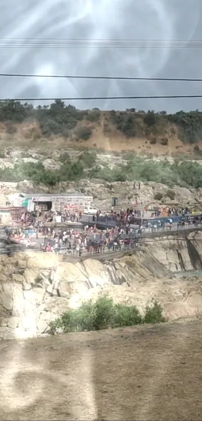 Crowded gathering on a scenic rocky cliffside landscape.