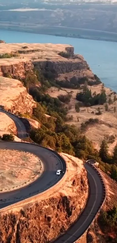 Aerial view of winding road on scenic cliffs by the water.