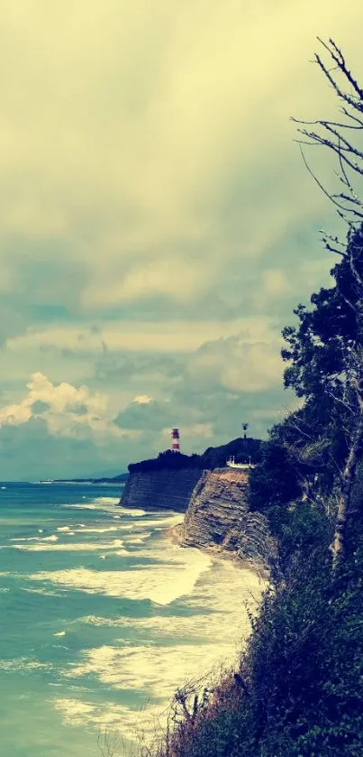 Coastal cliff with ocean and lush greenery under a cloudy sky.