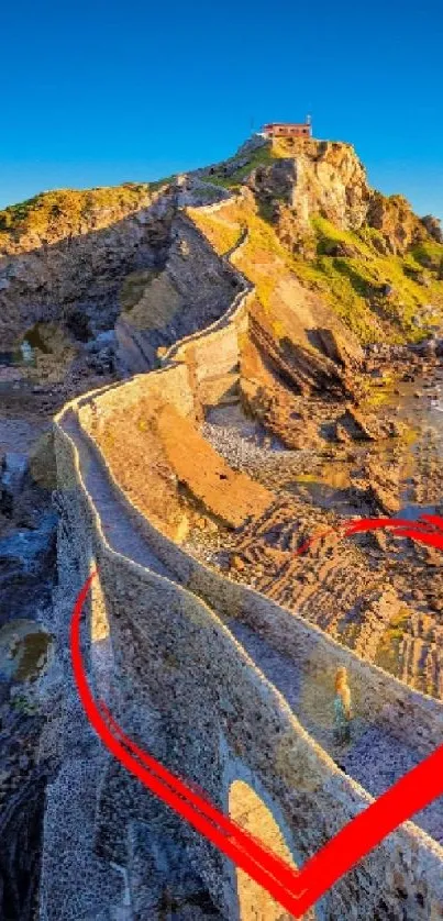 Scenic coastal path with red heart design under a bright blue sky.