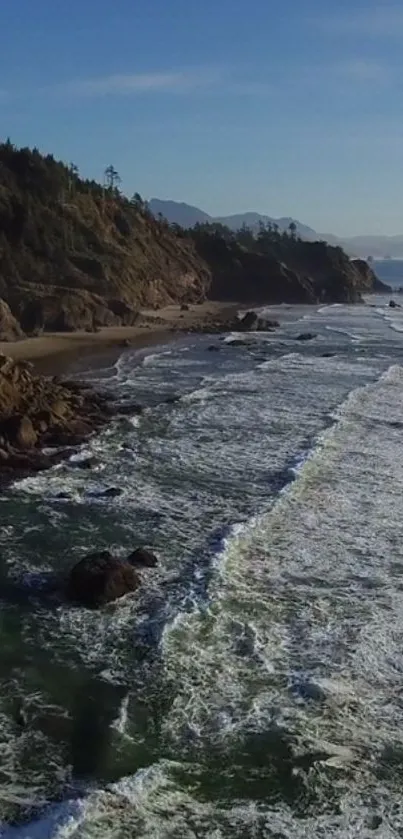 Coastal landscape with ocean waves and rocky shores under a blue sky.