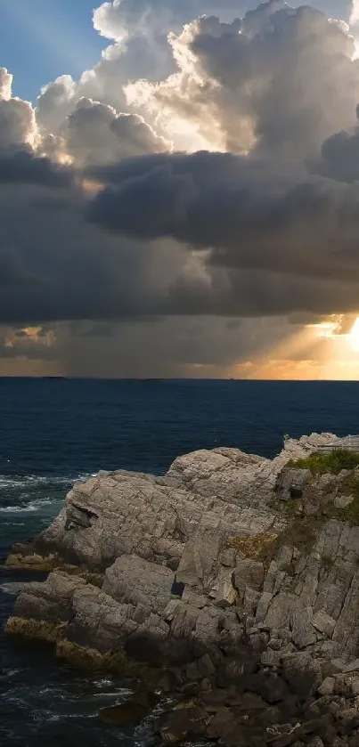 Lighthouse by the sea with dramatic sky and sunlight streaming through clouds.