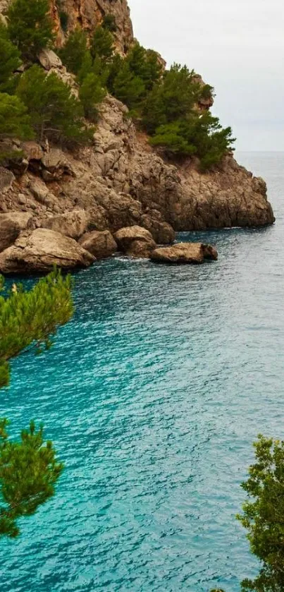 Scenic coastal view with cliffs and cyan blue sea under cloudy skies.