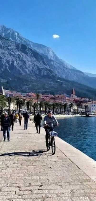 Scenic coastal walkway with mountains and sea.