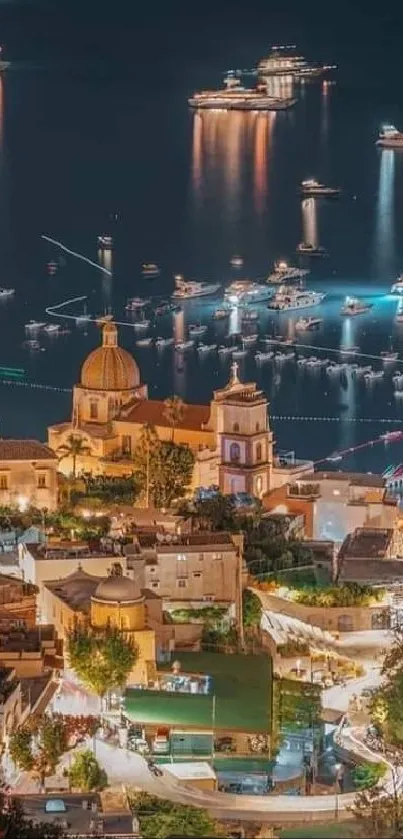 Italian coastal town illuminated at night with boats reflecting in the water.