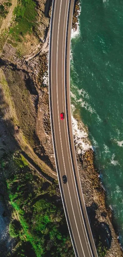 Aerial view of a scenic coastal road with ocean and landscape.