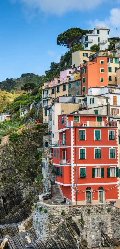 Colorful coastal town with ocean view and cliffside houses.