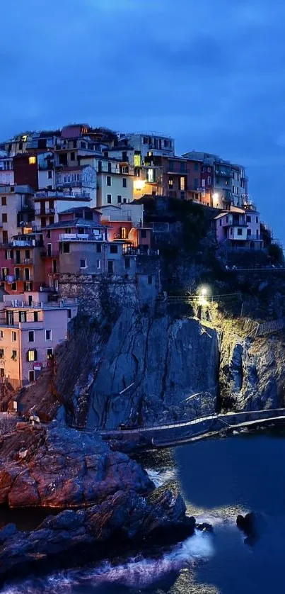 Scenic view of a coastal village at dusk with dramatic blue tones.