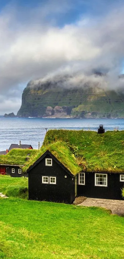 Coastal village with grass-roofed houses and dramatic cliffs.