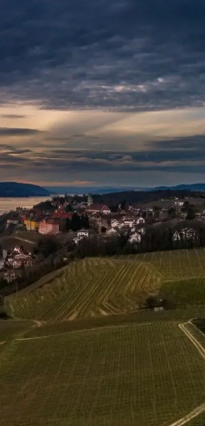 Scenic coastal village at dusk with rolling hills and dramatic sky.