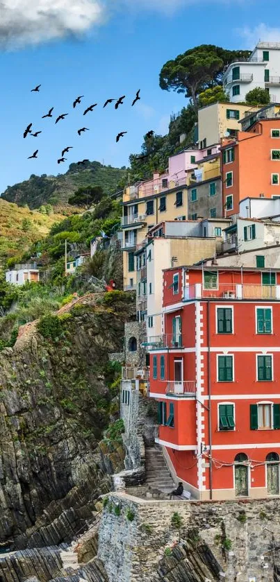 Colorful coastal village above a rugged seaside cliff.