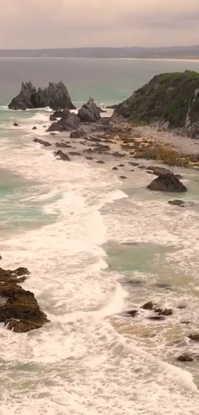 Coastal landscape with waves and rocks, perfect for a serene phone wallpaper.