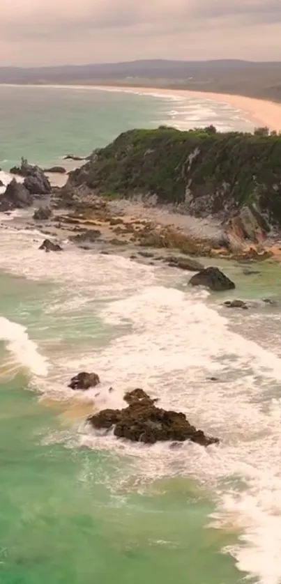 Beautiful coastal wallpaper with turquoise waves and rocky cliffs.