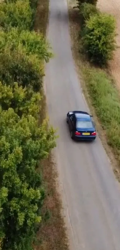 Car driving on a scenic country road surrounded by greenery.