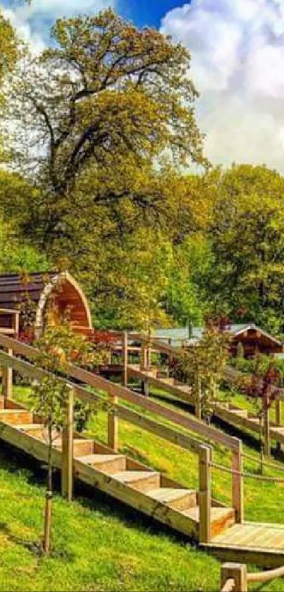 Scenic countryside view with cabins and lush greenery under a blue sky.