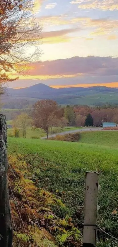 Scenic countryside sunset with lush green fields and vibrant autumn colors.